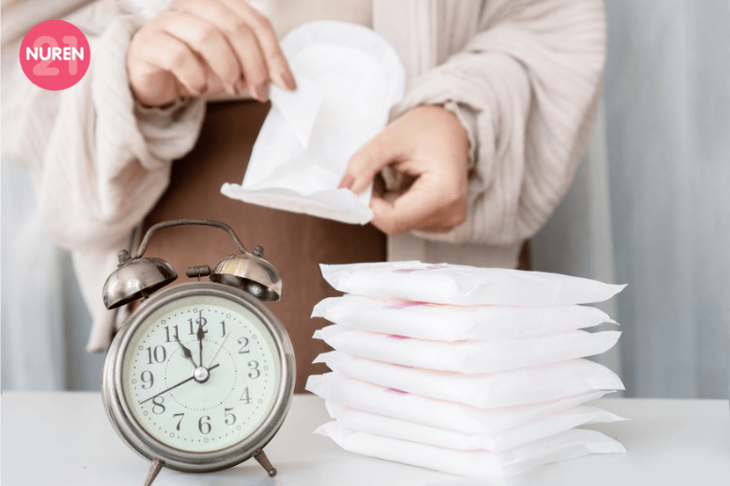 image of woman taking a new pad to maintain clean hygiene during period
