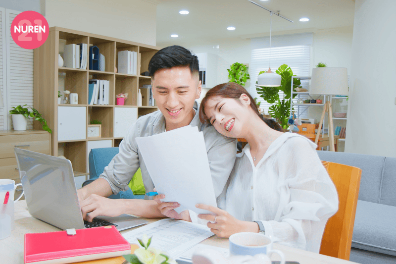 couple in the living room having healthy conversations on finances over a cup of tea