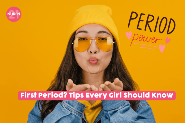 girl in yellow background and yellow beanie giving flying kiss
