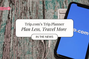 Trip.com showing on cellphone with earphones by the side