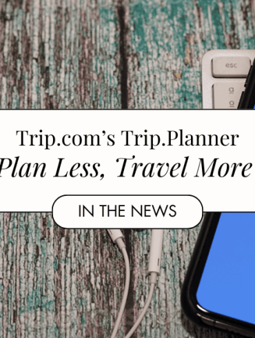 Trip.com showing on cellphone with earphones by the side
