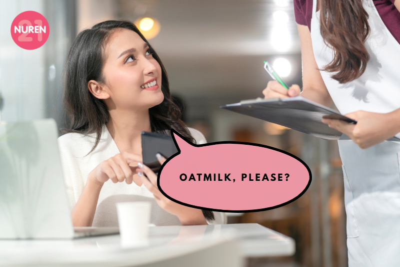 young gen z woman ordering oat milk