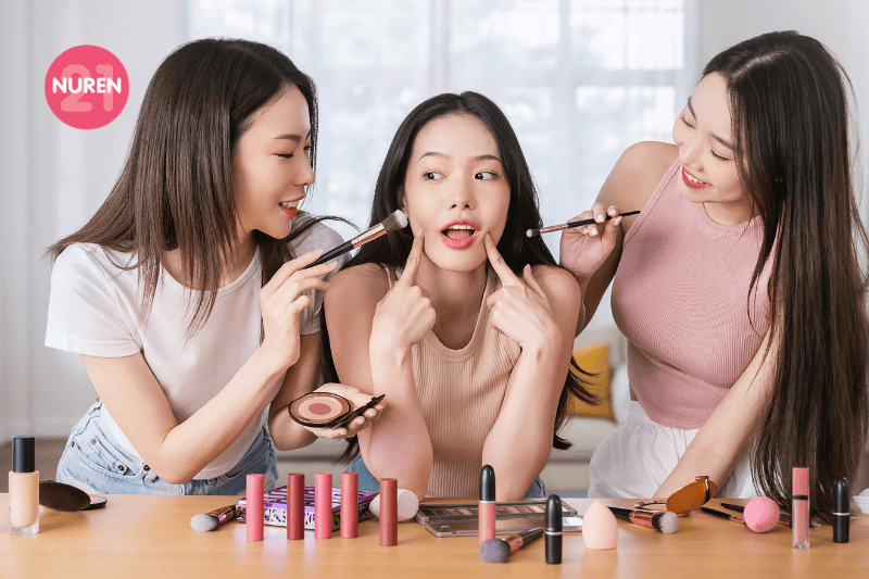 three girlfriends trying out new make up 