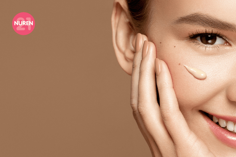 image of girl in isolated brown background smiling with nude colour theme on nails and cheeks