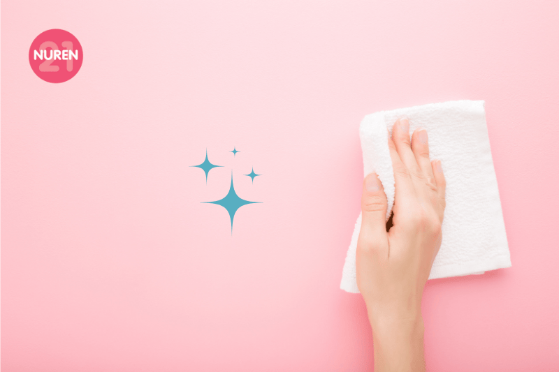 hands cleaning suface on isolated pink background with blue sparkles