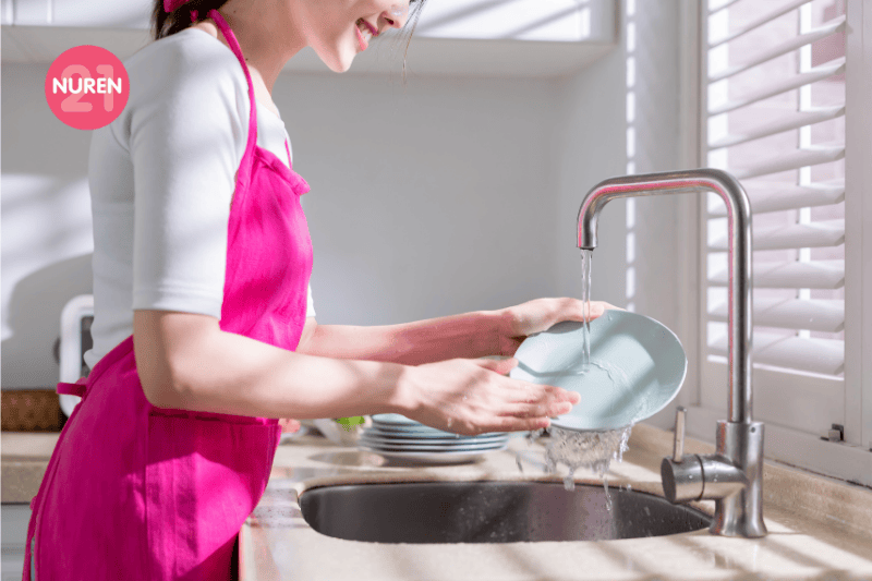 woman using natural cleaning detergent to wash dishes