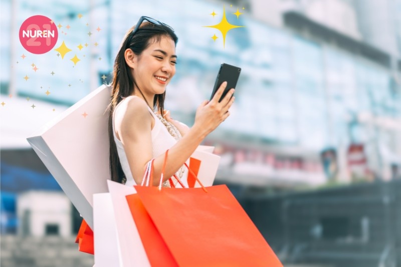 A happy woman shopping looking at her phone