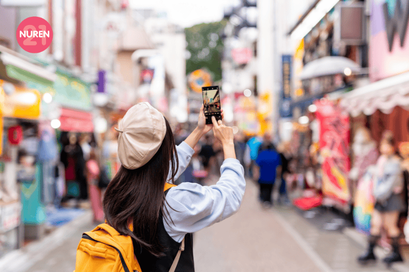 A tourist taking a photo in a fashion street 