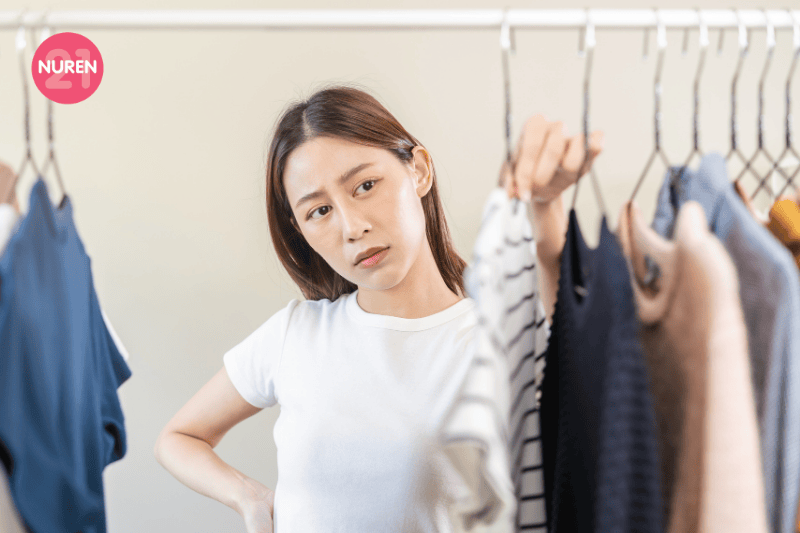 A woman looking through the clothing rack