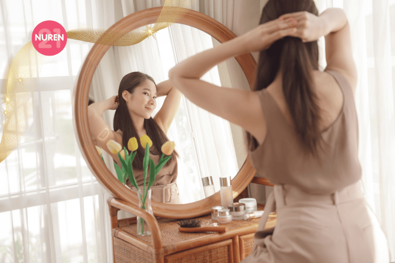 A woman getting herself ready in the mirror