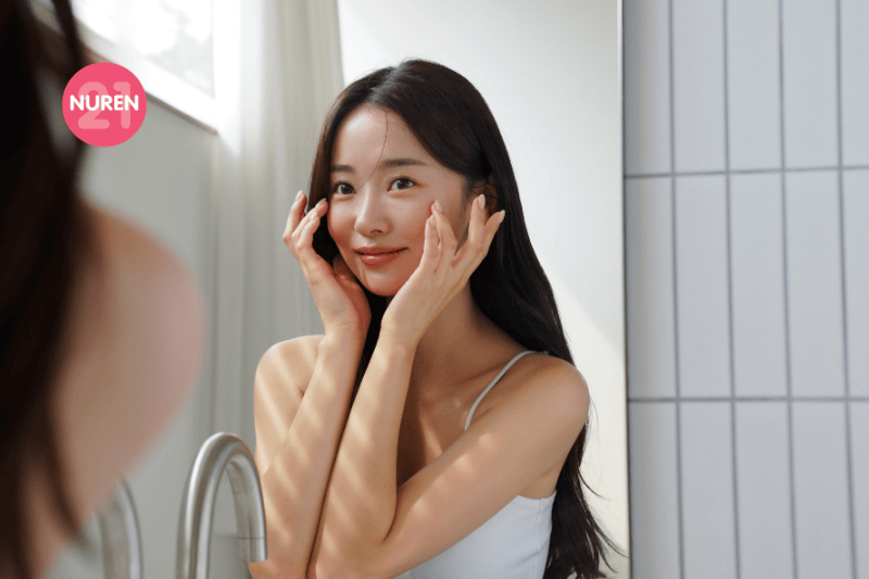 woman checking skin on mirror to determine skin type
