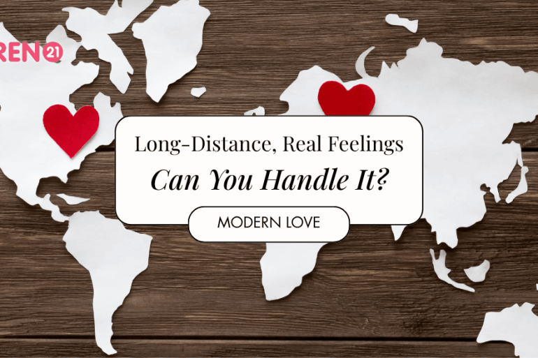 Red felt hearts and world map cut from white paper on the wooden background