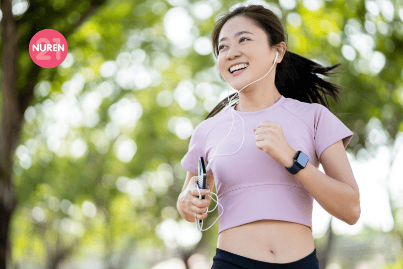 woman smiling while running in the park in the morning