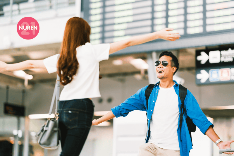 girl picking up her boyfriend at airport's arrival gate