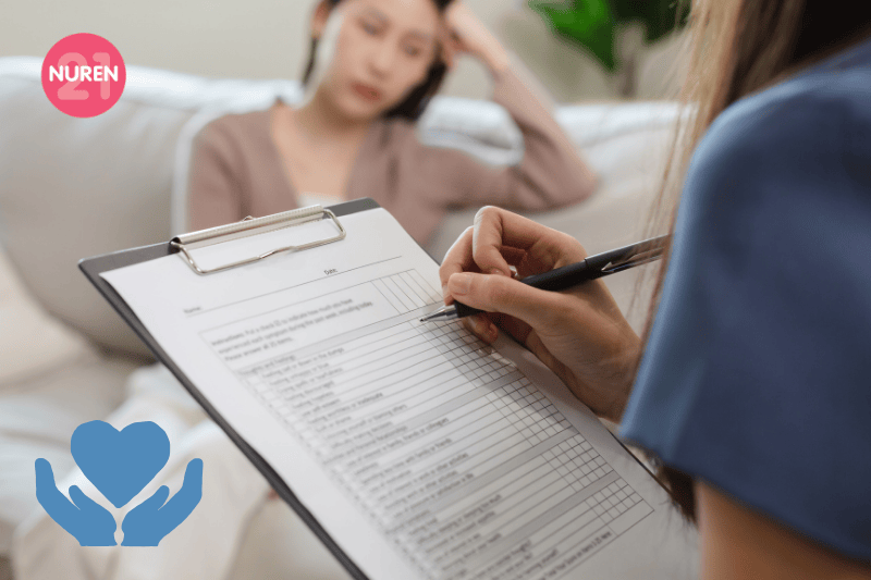 A woman at a therapists office while the therapist jots things down