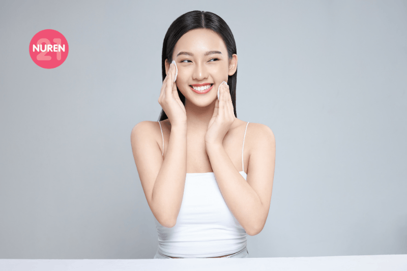 woman using toner on her skin