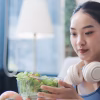 woman with headphone eating healthy meals active lifestyle