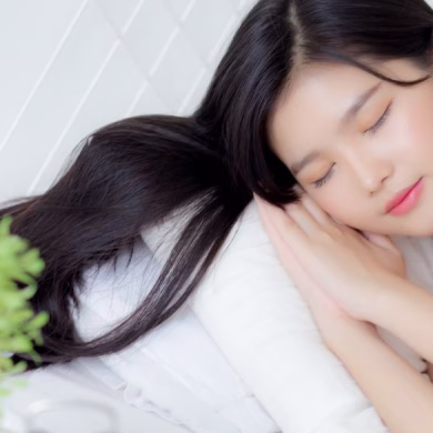 girl sleeping on bed with hair untied