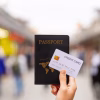 image of woman holding credit card and passport