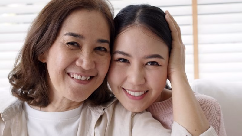 mother and daughter taking selfie together 
