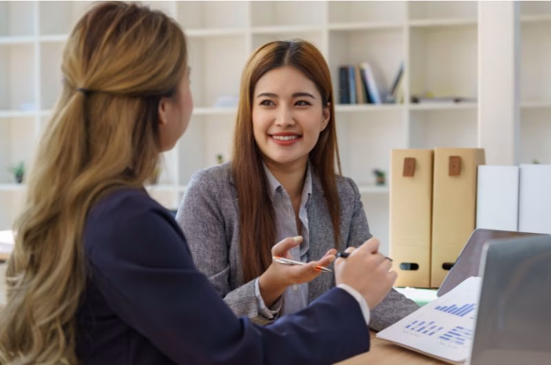 woman having conversation for details on personal loan and real estate investment
