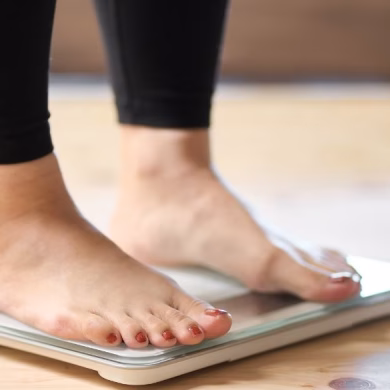 Feet of an Asian woman on a weight scale