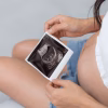 Pregnant woman holding baby ultrasound