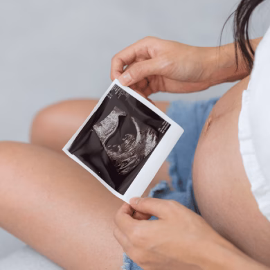 Pregnant woman holding baby ultrasound