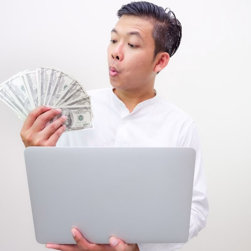 Asian businessmen, successful, financial wealth held greenback and computers that are happy in their work on a white background.