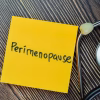 Concept of Perimenopause write on sticky notes with stethoscope isolated on Wooden Table.